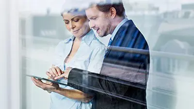 How You Connect to the Cloud Matters Two business people working on a tablet together