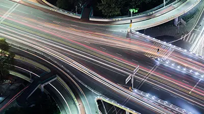 Digital Transformation Roadmap Highway outlined with neon multi-colored lines on the road.