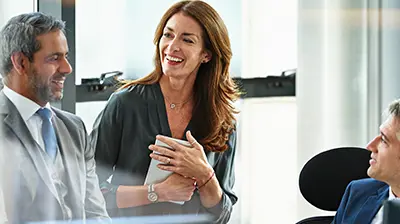 The 5 Benefits of Being a Digital Agency: Customer Satisfaction Two businessmen and a business woman having a discussion inside an office