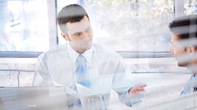 Deliver Faster, More Accurate Quotes with Applied A businessman explaining something to a colleague in a conference room