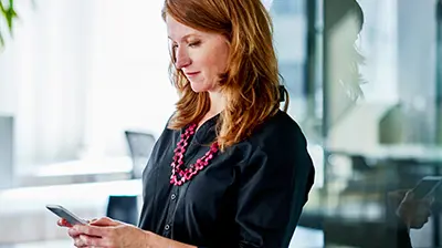 Insight Mobile Tools Woman in business casual attire using a phone